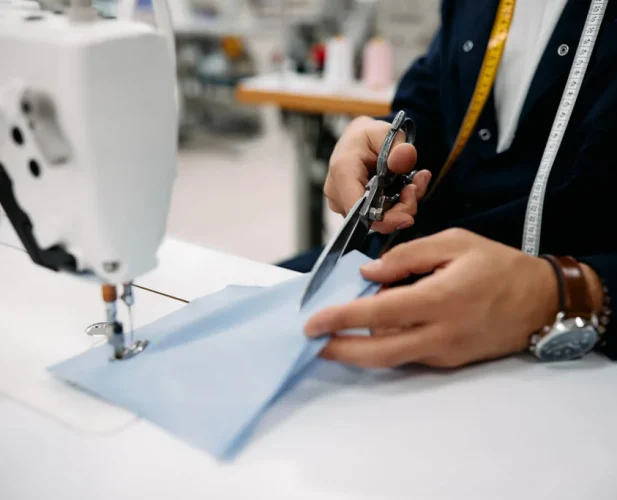 close-up-of-production-line-worker-cutting-fabric-PZW4NBZ-1024x683